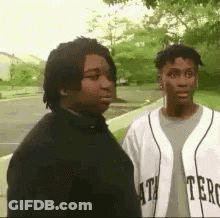Two Young Men On Sidewalk GIF