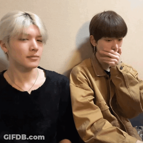 Two Young Men, One Covering Mouth GIF