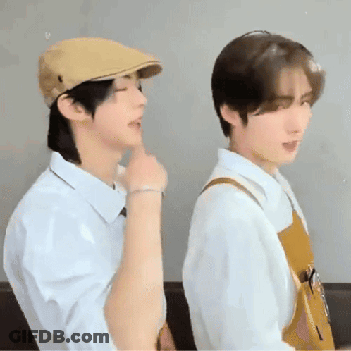 Two Young Men, One In Hat, One In Apron GIF