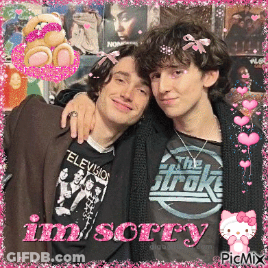 Two Young Men Posing For A Picture With The Words Im Sorry Written In Pink GIF
