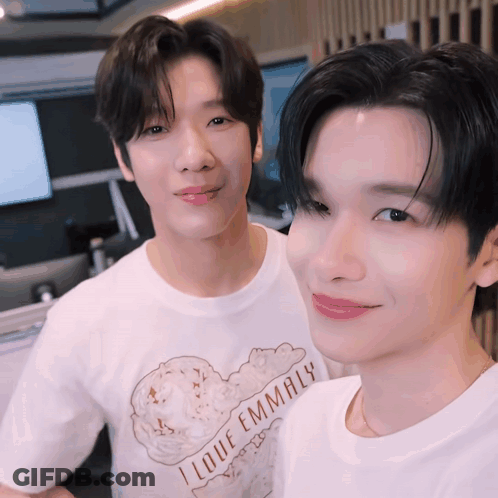 Two Young Men Posing For Picture One Wearing I Love Emmaly T-Shirt GIF