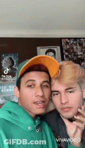 Two Young Men Posing One In Green Hoodie GIF