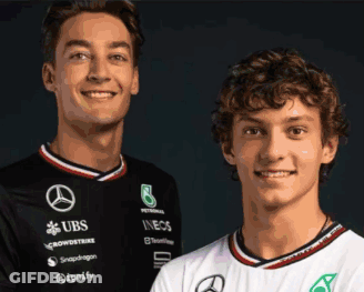 Two Young Men Posing One In UBS Shirt GIF