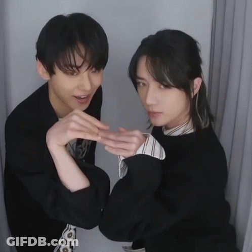 Two Young Men Posing One Making Heart With Hands GIF