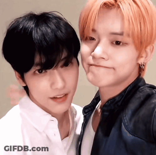 Two Young Men Posing One With Red Hair GIF