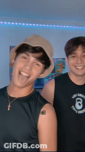 Two Young Men Posing With Tattoo Saying 8 GIF