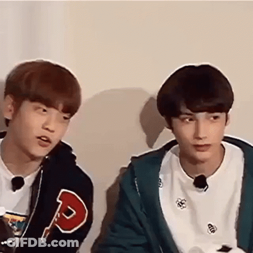 Two Young Men Sitting And Talking GIF