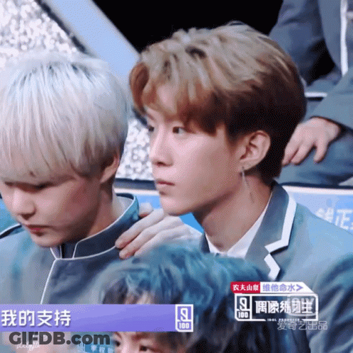 Two Young Men Sitting Next To Each Other GIF