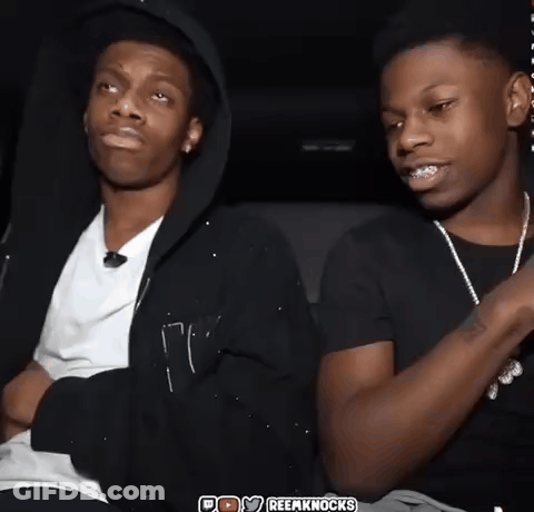 Two Young Men Sitting One Wearing Black Hoodie GIF