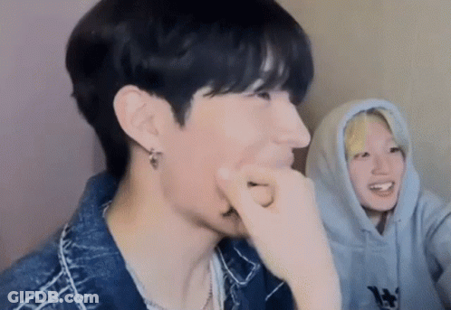 Two Young Men Sitting Together GIF