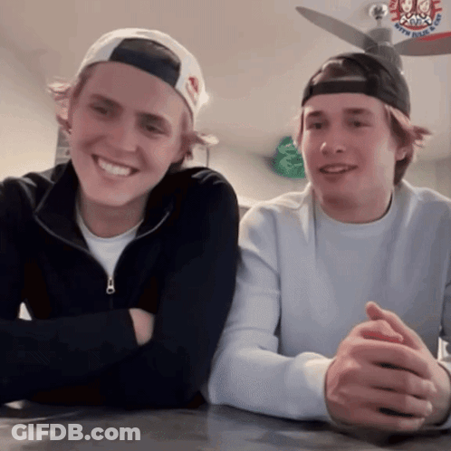 Two Young Men Sitting With Army Navy Air Force Hat GIF