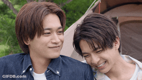 Two Young Men Smiling At Each Other GIF