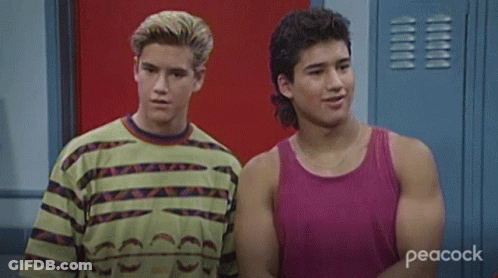 Two Young Men Smiling In Locker Room GIF