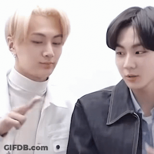 Two Young Men Standing And Looking At Each Other GIF