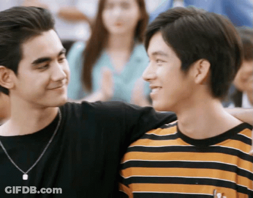 Two Young Men Standing And Smiling GIF
