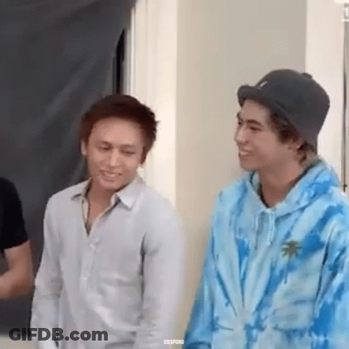 Two Young Men Standing And Smiling GIF