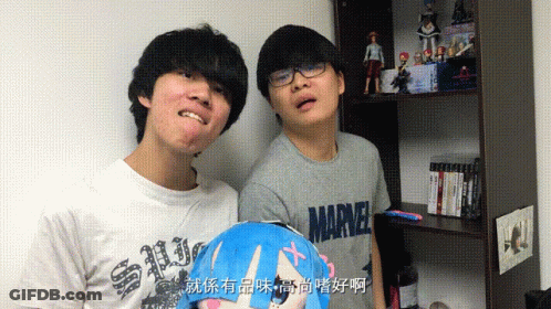 Two Young Men Standing Next To Each Other One Wearing A Marvel T-Shirt GIF