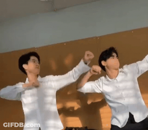 Two Young Men Standing Next To Each Other GIF