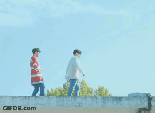 Two Young Men Standing On Ledge GIF