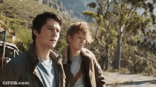 Two Young Men Standing On Mountain Road GIF