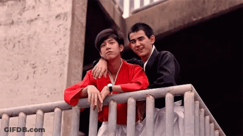 Two Young Men Standing On Railing GIF