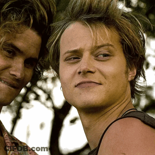 Two Young Men Standing One Smiling GIF