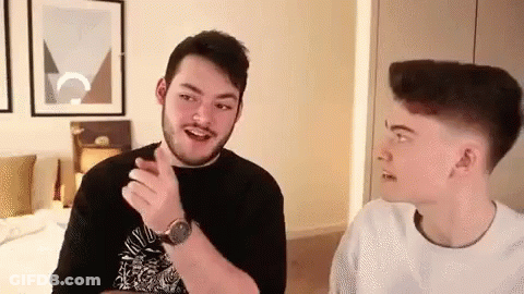 Two Young Men Talking In A Room GIF