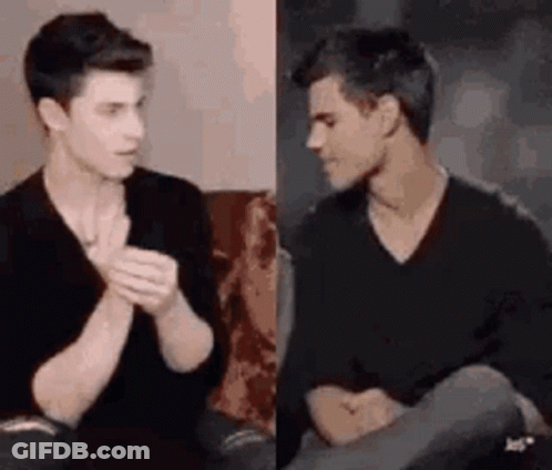 Two Young Men Talking On Couch GIF