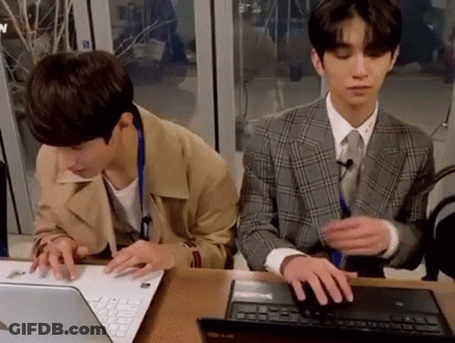 Two Young Men Using Laptop GIF