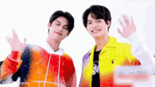 Two Young Men Waving Colorful Jackets GIF