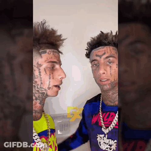 Two Young Men With Face Tattoos Standing Together GIF