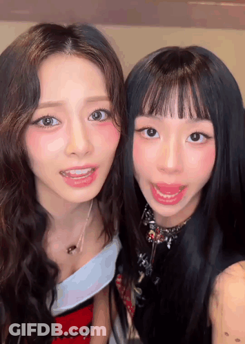 Two Young Women Are Posing For A Picture Together And Smiling For The Camera . GIF