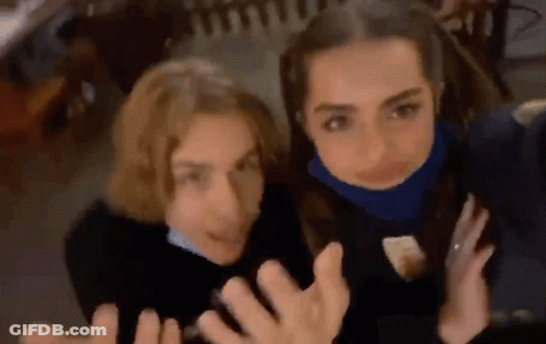 Two Young Women Are Posing For A Picture Together . GIF