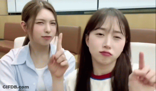 Two Young Women Making Funny Faces One Pointing Up GIF