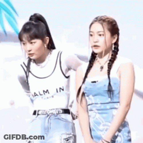 Two Young Women On Stage One Touching Other's Face GIF