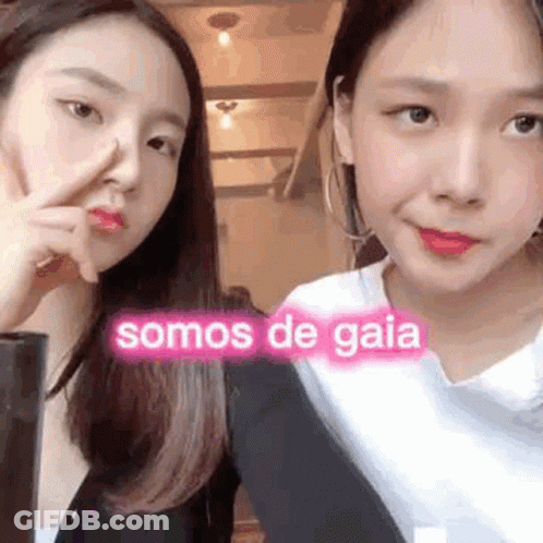 Two Young Women One Pointing At Nose GIF