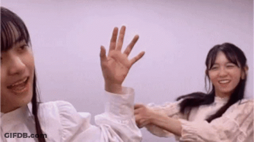 Two Young Women One Waving Hand GIF