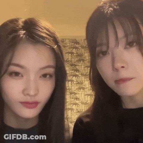 Two Young Women Standing Next To Each Other GIF