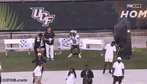 UCF Football Player Number 12 Kneeling On Field GIF