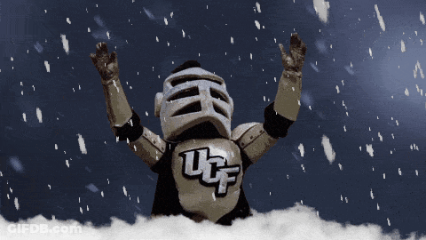 UCF Mascot Standing In Snow With Arms In Air GIF