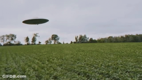 UFO Flying Over Grassy Field GIF
