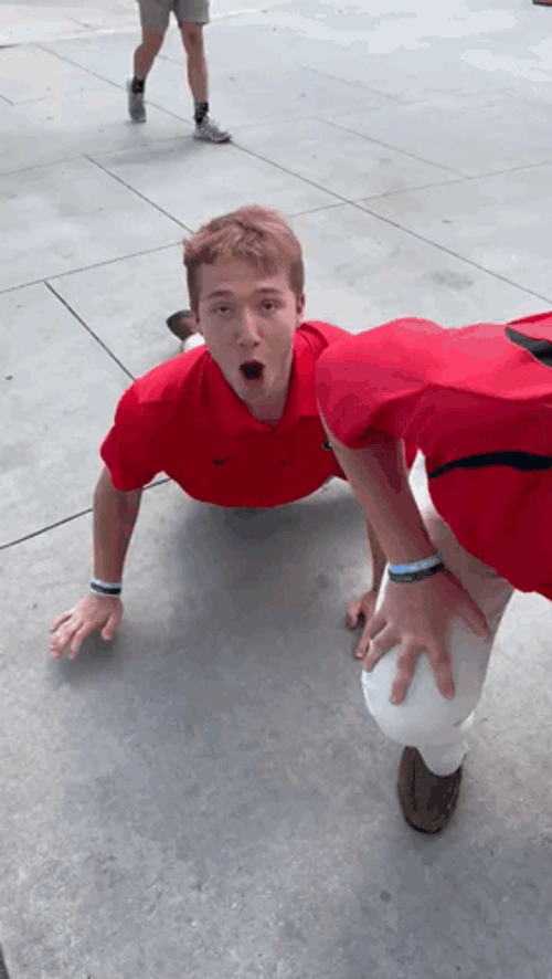 Uga Bulldogs Fans Crawling On Sidewalk GIF