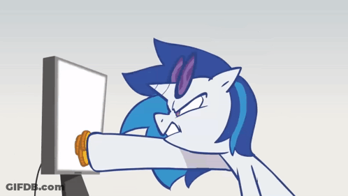 Unicorn Eating Cookie In Front Of Computer GIF
