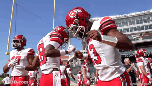 Utah Football Players Huddled On Field GIF