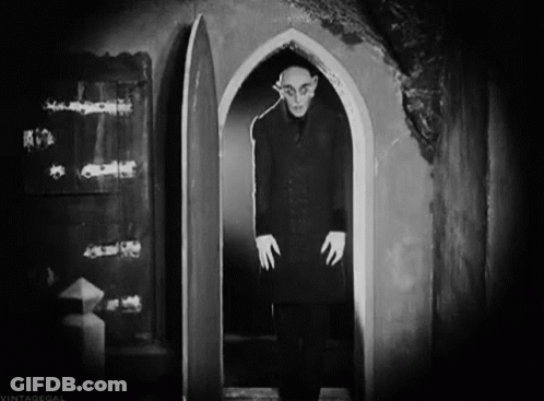 Vampire Holding Woman With Castle Background GIF