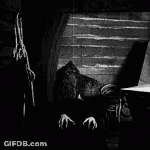 Vampire With Claws In Dark Room GIF