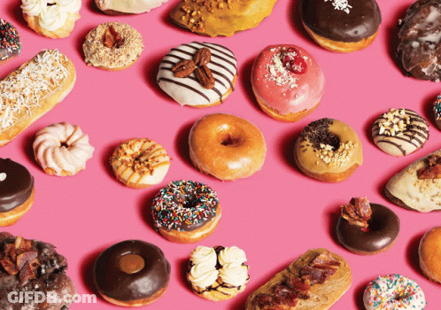 Variety Of Donuts Lined Up On Pink Surface GIF