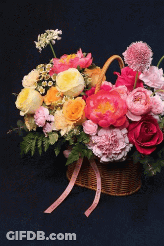 Vase With Yellow And Blue Flowers Against Dark Blue Background GIF