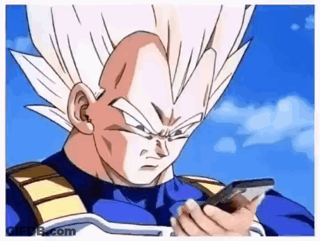 Vegeta From Dragon Ball Z Is Holding A Cell Phone In His Hand . GIF