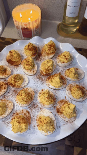 Vegetable Oil Candle Next To Stuffed Eggs GIF
